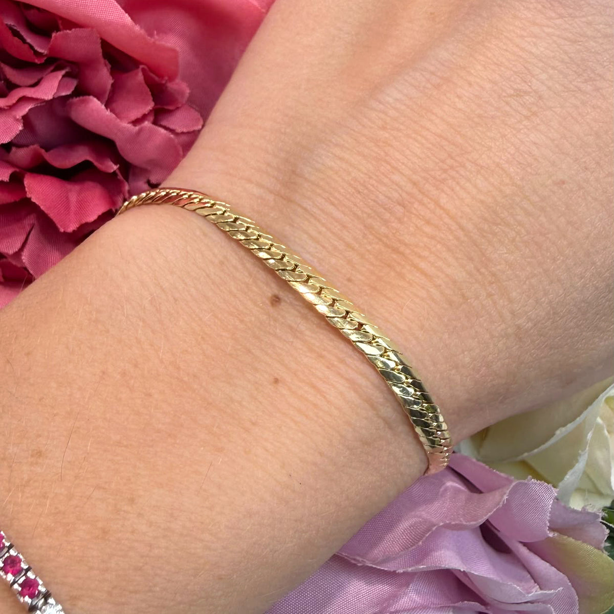 BRACCIALE A MAGLIA PIATTA LAVORATA IN ORO GIALLO 18 KT