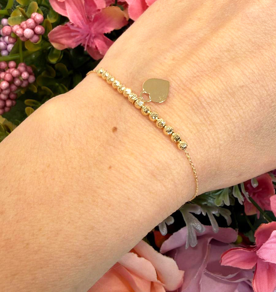 Bracciale con sfere diamantate e cuore in oro giallo 18 KT (750)